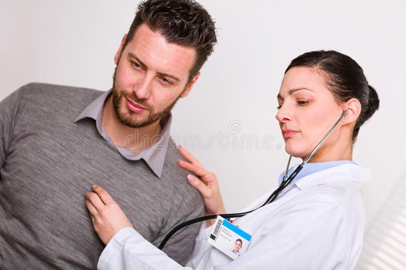 Listening to adult female heart beat with stethoscope