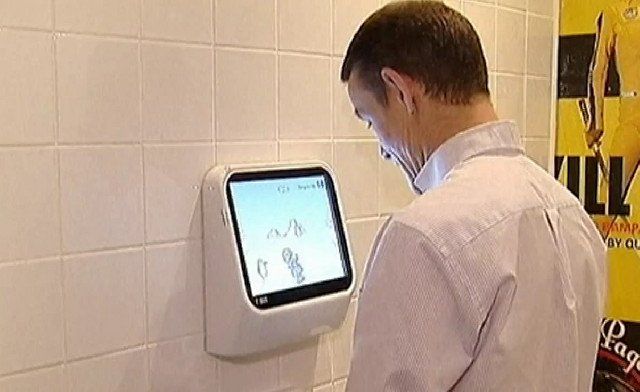 Men peeing into urinals