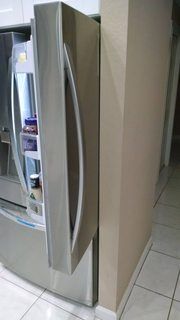 Refrigerator door stop swinging open